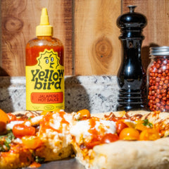Yellowbird pouring over tacos demonstrating easy tabletop serving
