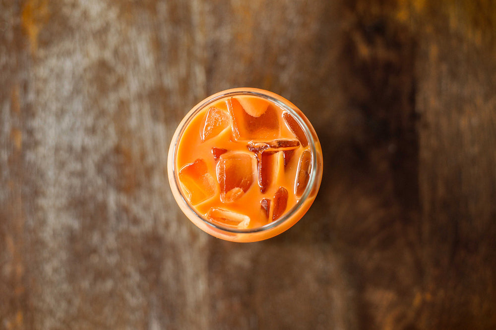 Yim Tea Co. Thai milk tea cup with boba illustrating strong flavor and creamy finish