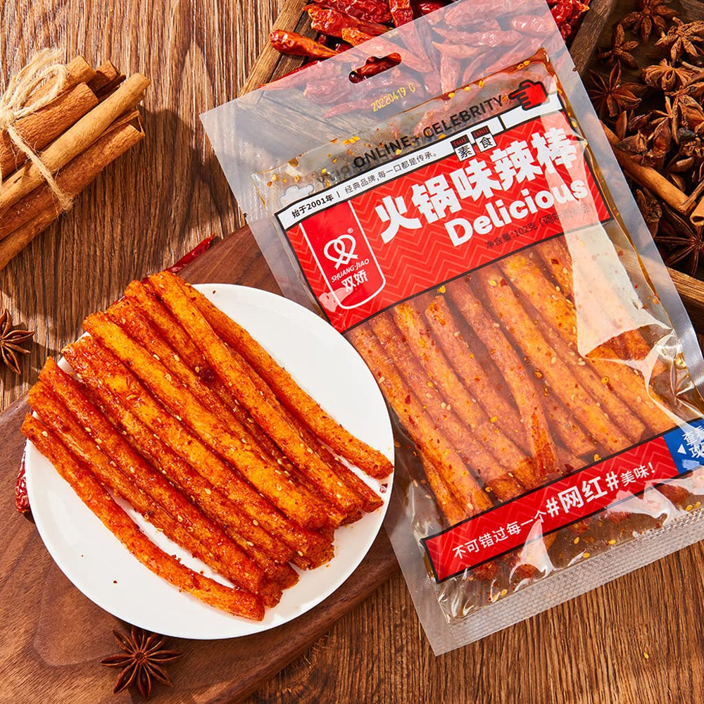 YMeijian spicy sticks on a table with beverage showing social snack use and bold flavor enjoyment