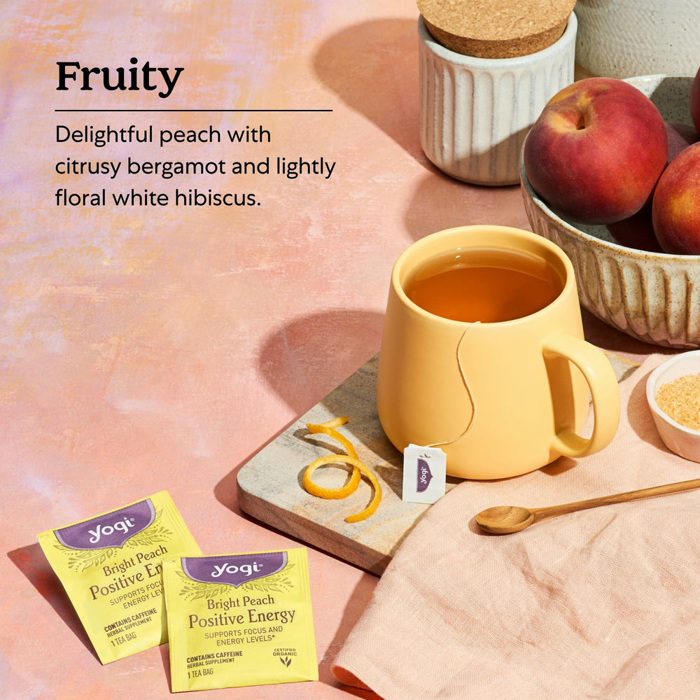Yogi pouring hot Bright Peach tea into cup for a comforting boost