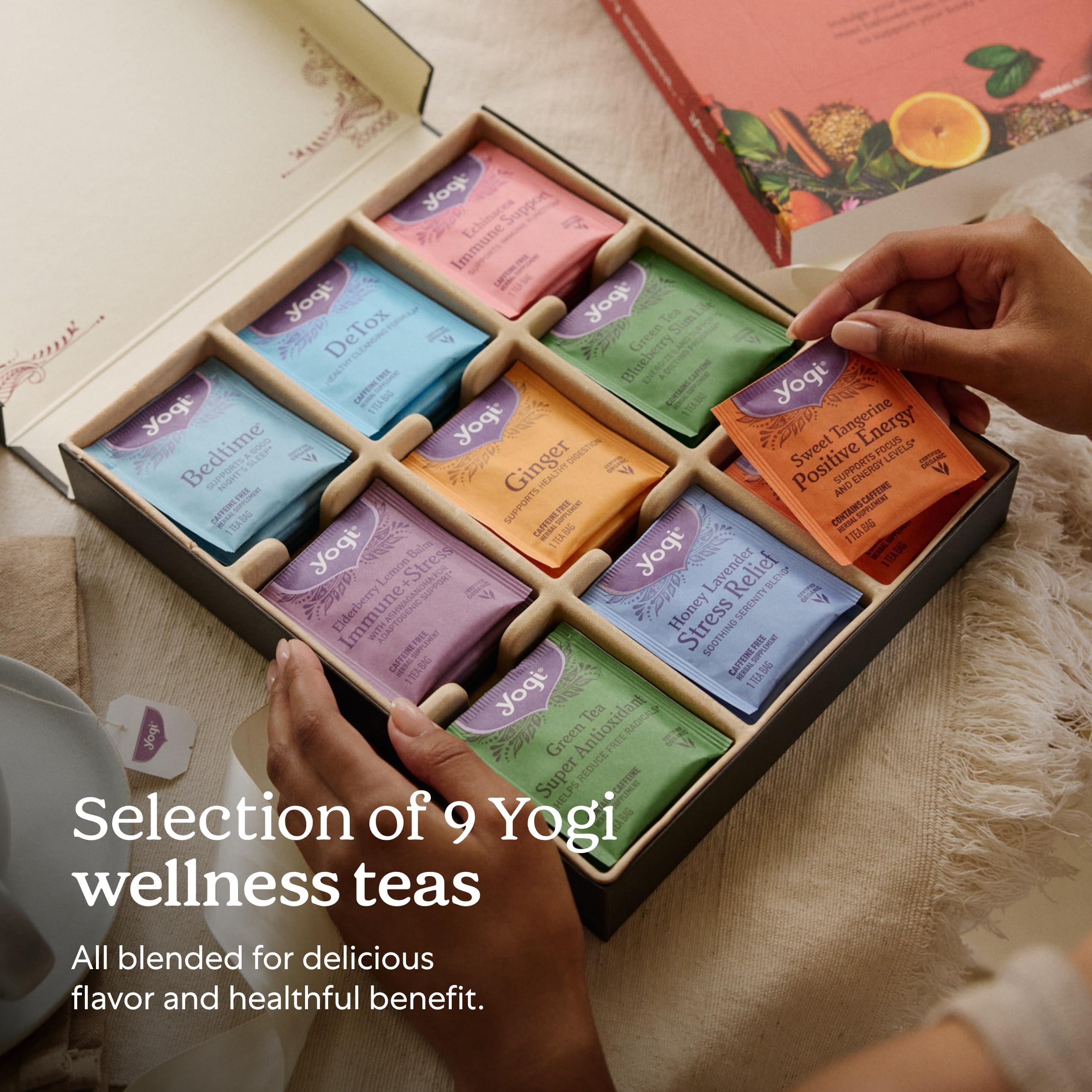 Hand holding a Yogi tea envelope to show scale and single-cup convenience