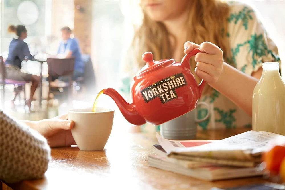 Yorkshire Tea pack beside a coffee mug showing scale and 200-count value