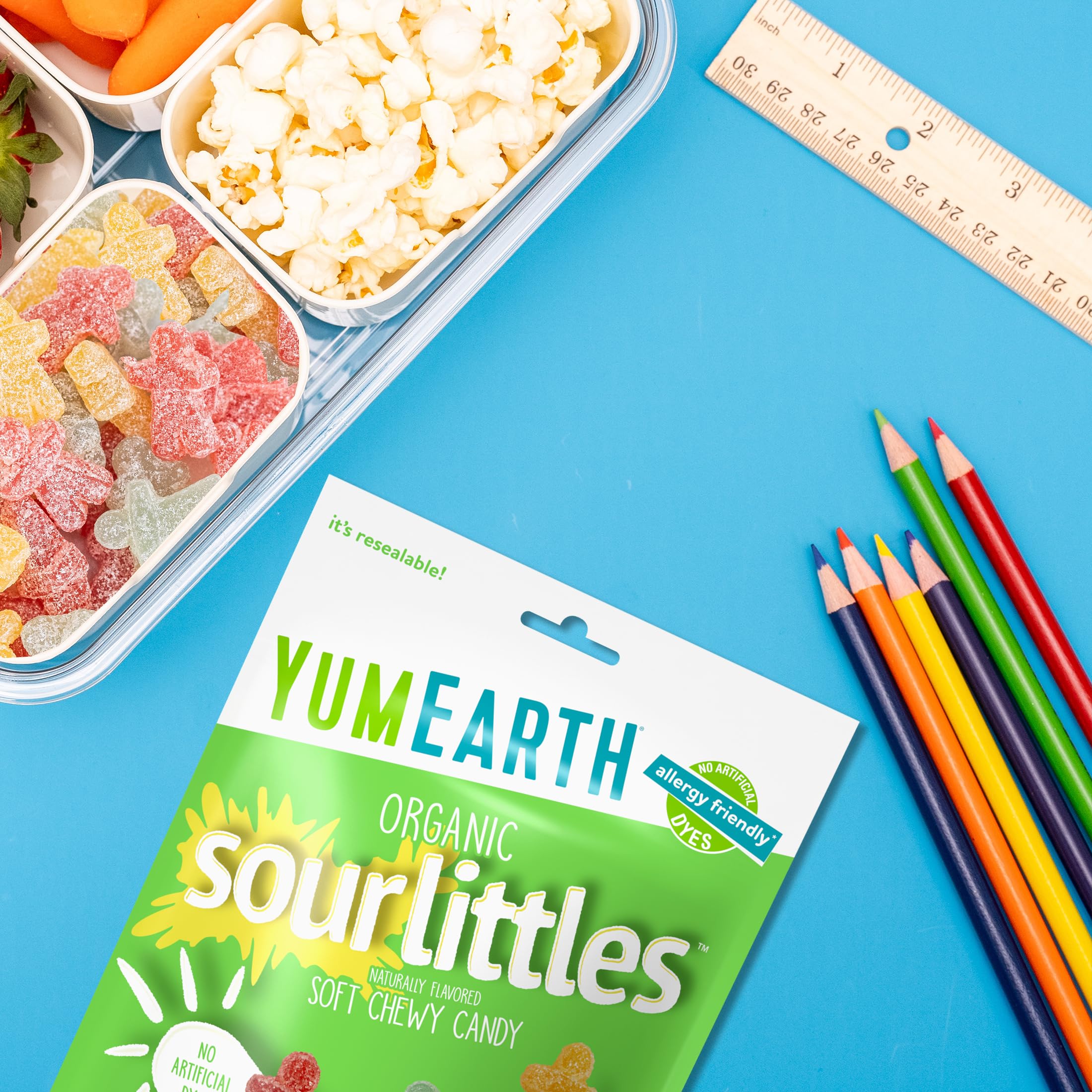 YumEarth candy in hand to illustrate size and kid-friendly portion