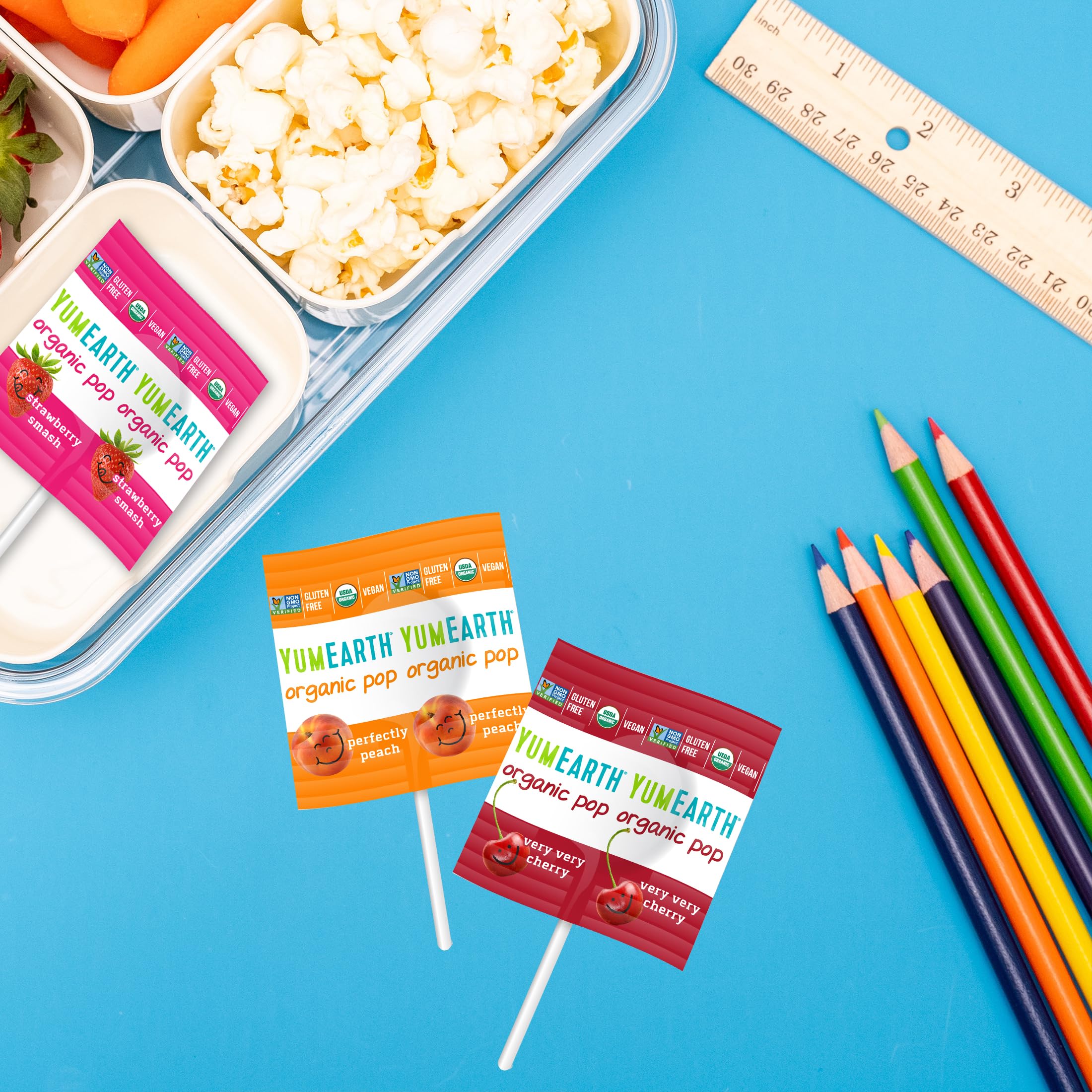 YumEarth lollipop held in hand to demonstrate size and portion clarity