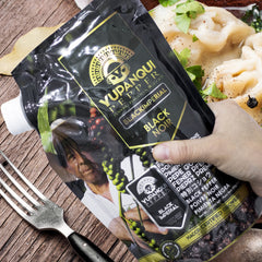 Yupanqui pouring peppercorns from refill bag into grinder for easy use