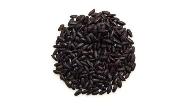 Yupik cooked ancient black rice close-up with purple hue, flavorful texture