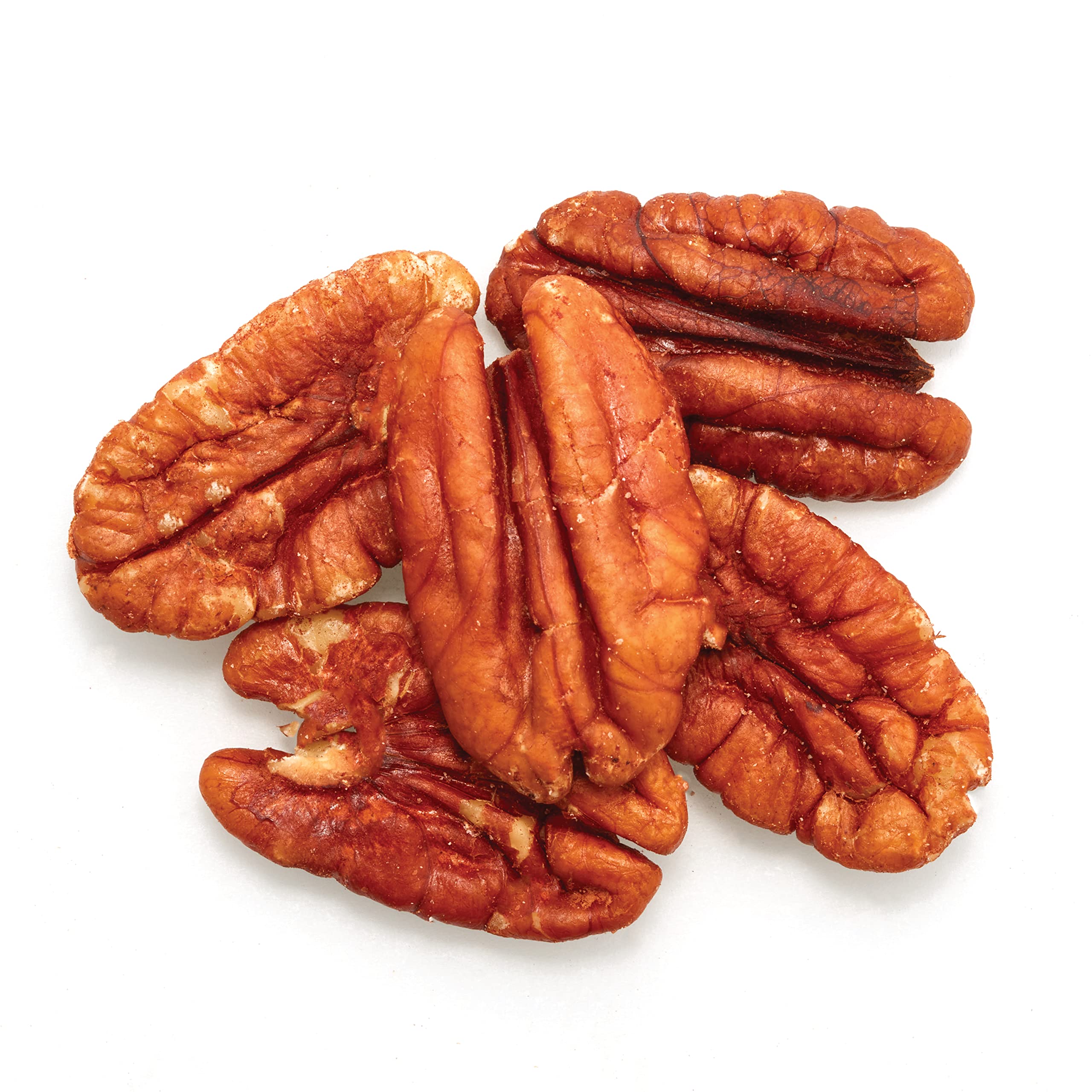 Close-up of Yupik pecan halves highlighting crunchy texture and buttery look