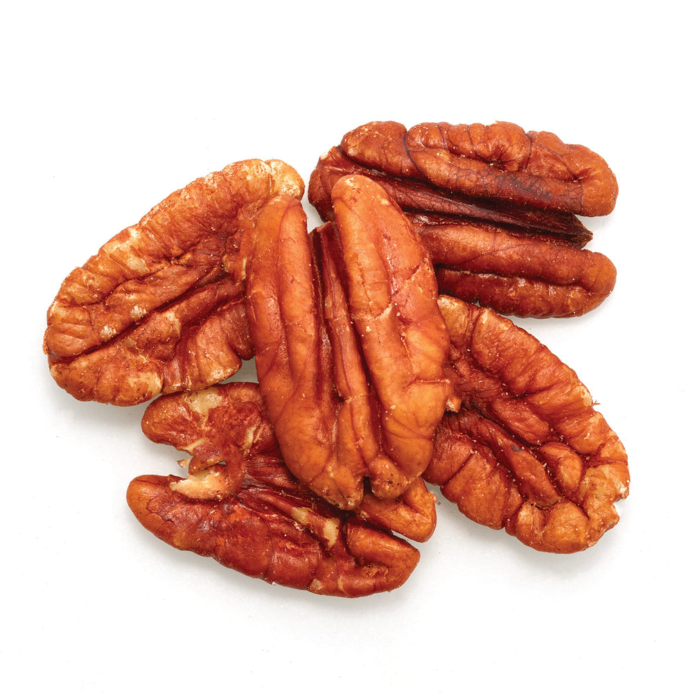 Close-up of Yupik pecan halves highlighting crunchy texture and buttery look