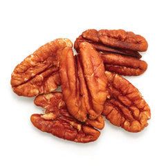 Close-up of Yupik pecan halves highlighting crunchy texture and buttery look