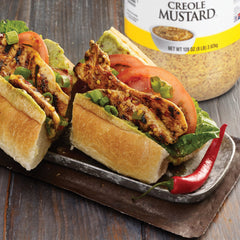 Zatarain's mustard spread on a po'boy sandwich adding bold Creole flavor